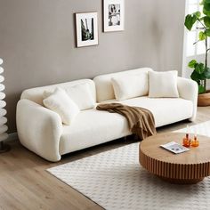 a living room with a white couch and coffee table