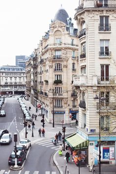 people are crossing the street in front of buildings