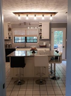 a kitchen with two bar stools in it