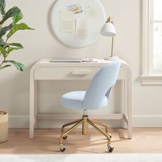 a blue chair sits in front of a white desk