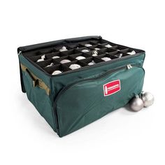 a large green case filled with lots of silver balls on top of a white floor