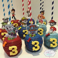 there are many cupcakes made to look like the characters from paw patrol on cake