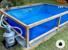 a blue pool is being built in the yard