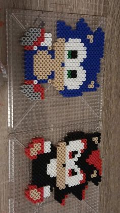 three legos made to look like sonic and mario bros characters are on display in a clear plastic case