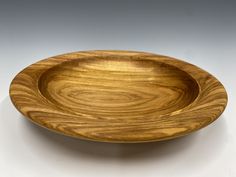 a wooden plate on a white surface with no one around it or in the photo