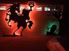 a halloween scene with a horse and pumpkin on the garage door