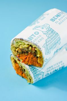 a wrapper filled with food sitting on top of a blue surface