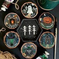 halloween decorations are arranged on top of wood slices