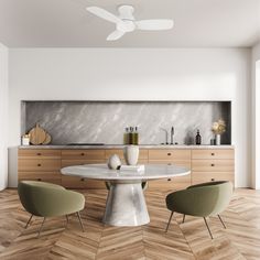 a modern kitchen with white walls and wood flooring, two green chairs sit at the table