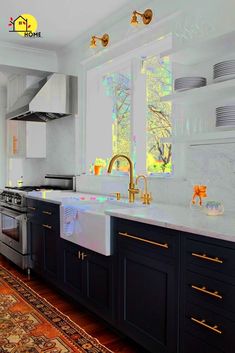 a large kitchen with black cabinets and white counter tops, gold pulls on the faucet