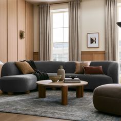 a living room with two couches and a coffee table in front of large windows