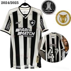 a black and white soccer jersey with the number 24 on it, next to a medal