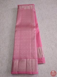 two pink sarees sitting on top of a white table next to each other