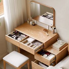 a wooden desk with drawers and a mirror