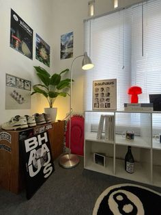 a room with various items on the floor and a plant in the corner next to it