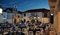 tables and chairs are set up outside at night