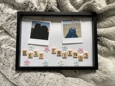 two pictures hanging on clothes pins with the word best friends spelled in scrabbles