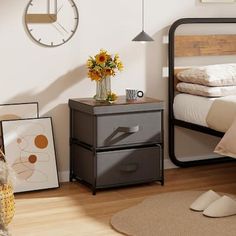 a bedroom with a bed, two nightstands and a large clock on the wall