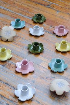 small cups and saucers are arranged on the floor in order to be made into teacups