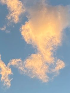 an airplane is flying in the sky with clouds