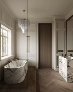 an elegant bathroom with marble tub and sink