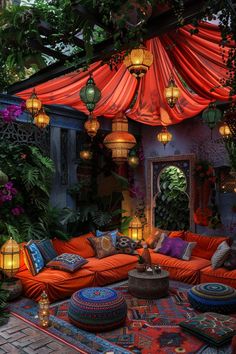 an outdoor living room with lots of pillows and lights