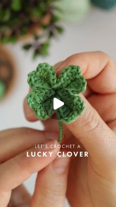 someone is crocheting a lucky clover for st patrick's day