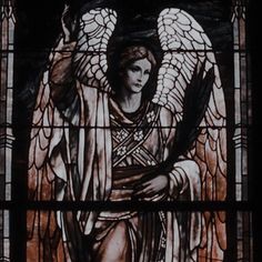 a stained glass window with an angel on it