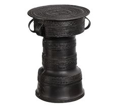 a black and white photo of an old fashioned stool with straps on the top, sitting in front of a white background