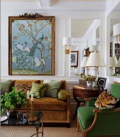 a living room filled with furniture and a painting on the wall above it's fireplace