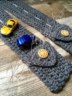 two crocheted wristbands with cars on them sitting next to each other