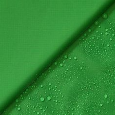 green fabric with drops of water on the bottom, and an image of a background