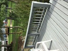 a white bench sitting next to a wooden fence