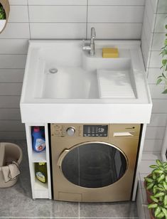 a kitchen sink with the door open next to a washer and dryer combo