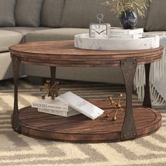 a living room with a couch, coffee table and rugs on the floor in front of it