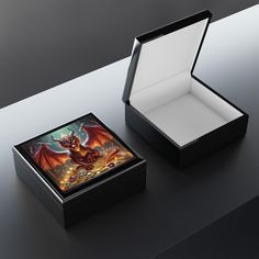 an open box with a dragon on the front and inside, sitting on a table