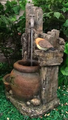 a bird sitting on top of a water fountain