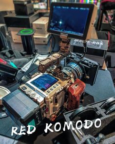 many electronic devices are sitting on top of a table with the words red komodo above them