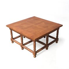 a wooden table with two legs and a square top