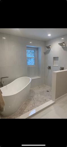 a bathroom with a large bathtub next to a walk - in shower and sink