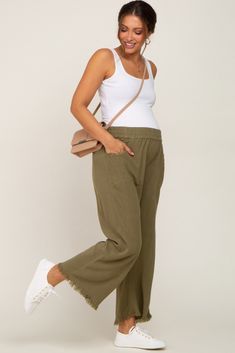 A pair of crop length, linen maternity pants featuring an elastic waistband, side pockets, and fringe trim. The Olive Linen Frayed Hem Crop Maternity Pants is perfectly bump-friendly! Linen Pants Outfit Pregnant, Linen Pregnancy Outfit, Linen Maternity Pants, Linen Pants Maternity Outfit, Maternity Wide Leg Pants Outfit, Linen Pants Pregnancy Outfit, Comfy Pregnancy Outfits Summer, Olive Linen Pants Outfit, Stylish Maternity Outfits Summer