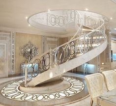 a large spiral staircase in the middle of a room with marble floors and white walls