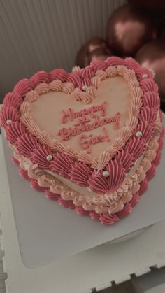 a heart shaped cake sitting on top of a table