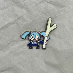 a lapel with a cartoon character holding a baseball bat on it's back