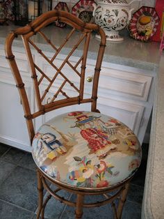 a bamboo chair sitting in front of a counter top next to a vase with flowers on it