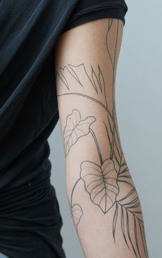 a person with a flower tattoo on their arm and the words tropics with a hint of matissee s