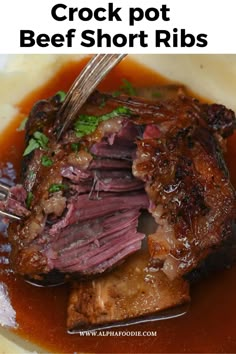 crock pot beef short ribs with gravy and garnish on top