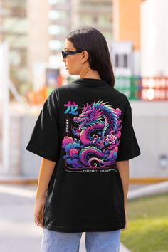 Embrace the power, luck, and charisma of the dragon with our 'Year of the Dragon Sweatshirt.' This stunning sweater pays homage to the Chinese zodiac's Year of the Dragon, symbolizing strength, wisdom, and good fortune. Get yours now! Available on tshirts, sweatshirt and hoodies: https://www.etsy.com/shop/TheNims?search_query=Year+Of+The+Dragon Browse through my other awesome items here: http://thenims.etsy.com/ UNISEX TEES Gildan 5000™ (CUSTOMER FAVORITE) * 100% Cotton (fiber content may vary f Black Crew Neck T-shirt With Dragon Print, Short Sleeve Tops With Dragon Print For Streetwear, Dragon Print Crew Neck Top For Streetwear, Casual Dragon Design Tops For Streetwear, Streetwear Dragon Print Short Sleeve T-shirt, Streetwear Short Sleeve T-shirt With Dragon Print, Casual Tops With Dragon Design For Streetwear, Dragon Sweatshirt, Chinese Streetwear