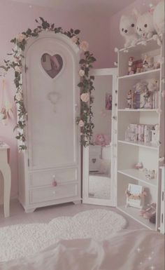 a bedroom with pink walls and white furniture in the corner is decorated with flowers, teddy bears and stuffed animals