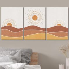 three paintings on the wall above a bed